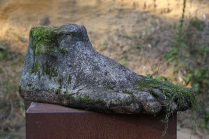 Weathered & Overgrown Stone Foot by Anon Unknown at The Sculpture Park